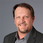 Head shot of a man wearing a dark jacket