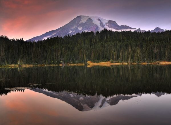 Striking image of a mountain reflected across in a lake at dusk