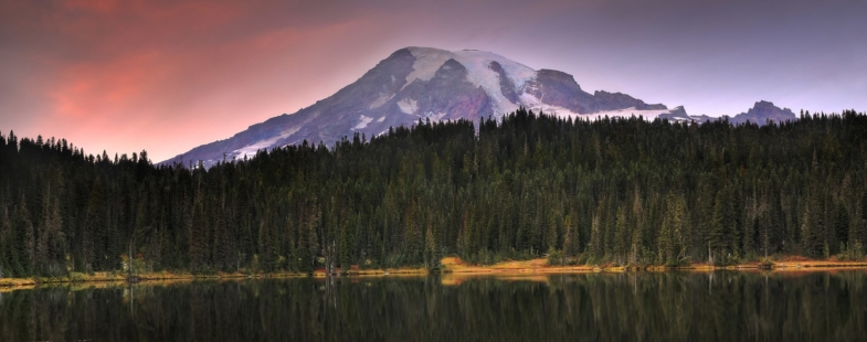 Striking image of a mountain reflected across in a lake at dusk