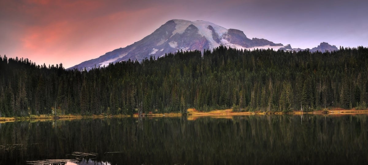 Striking image of a mountain reflected across in a lake at dusk