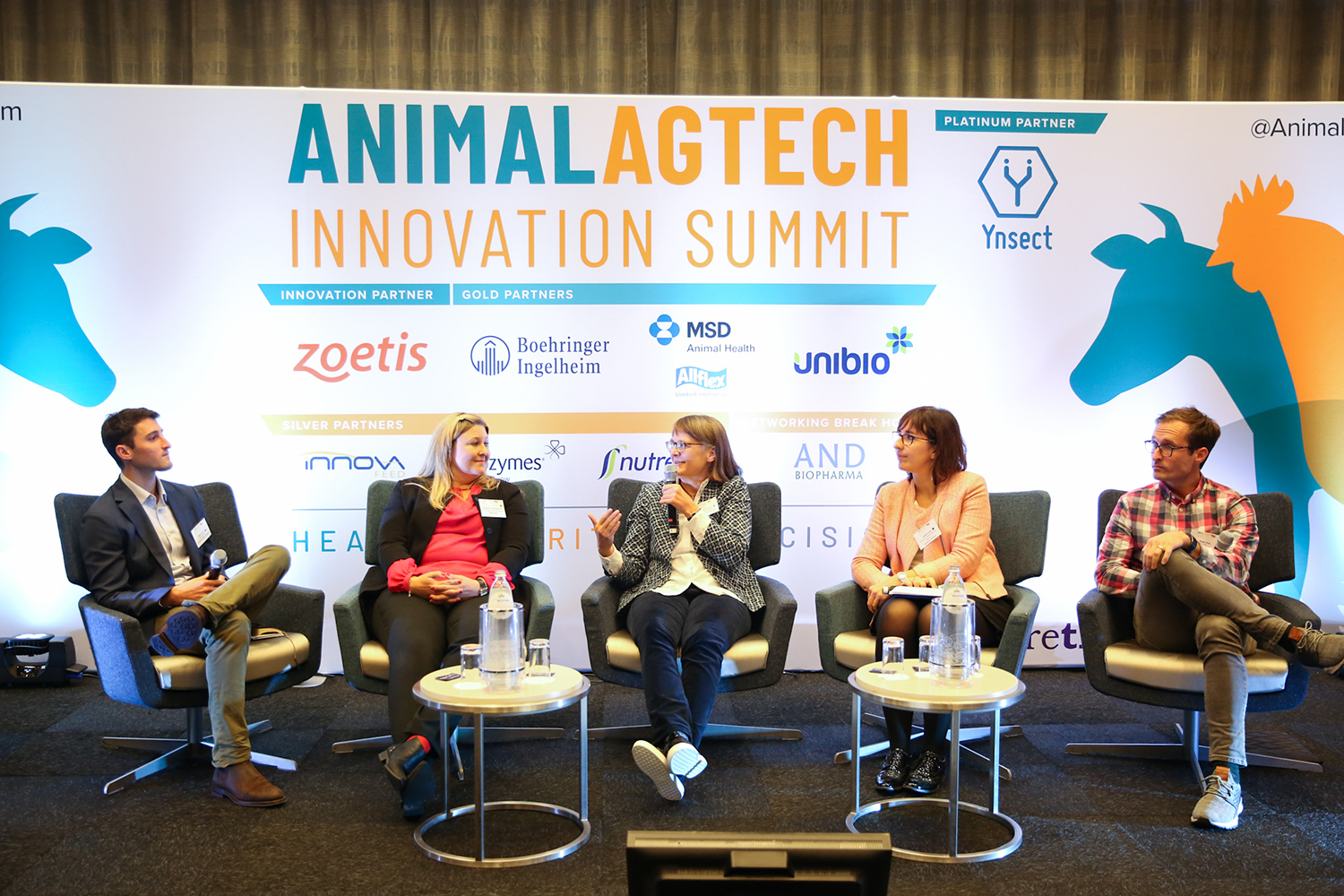 A panel of people on a stage at a trade summit 