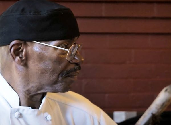 Side profile of a black male chef facing away from the camera