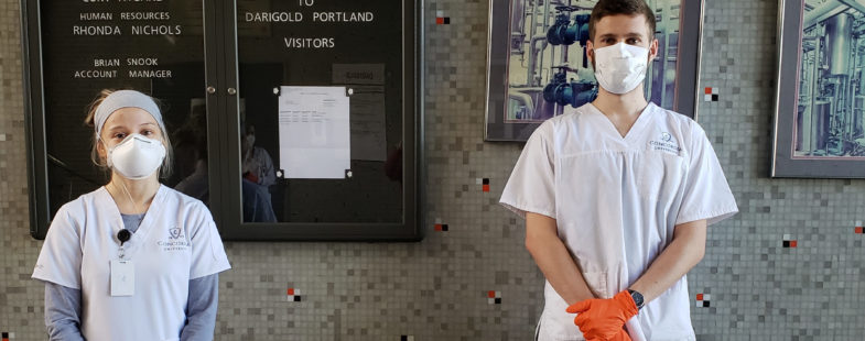 Two nursing students wearing PPE pose for the camera