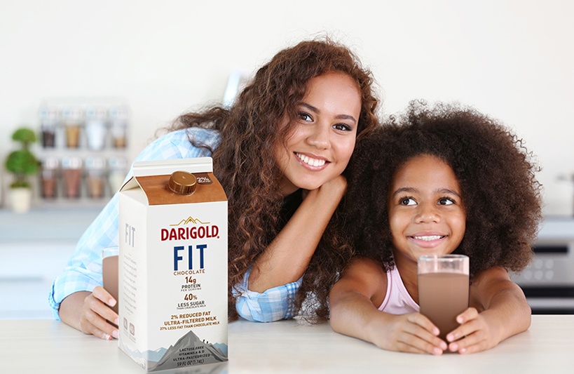 Two young females pose with chocolate milk