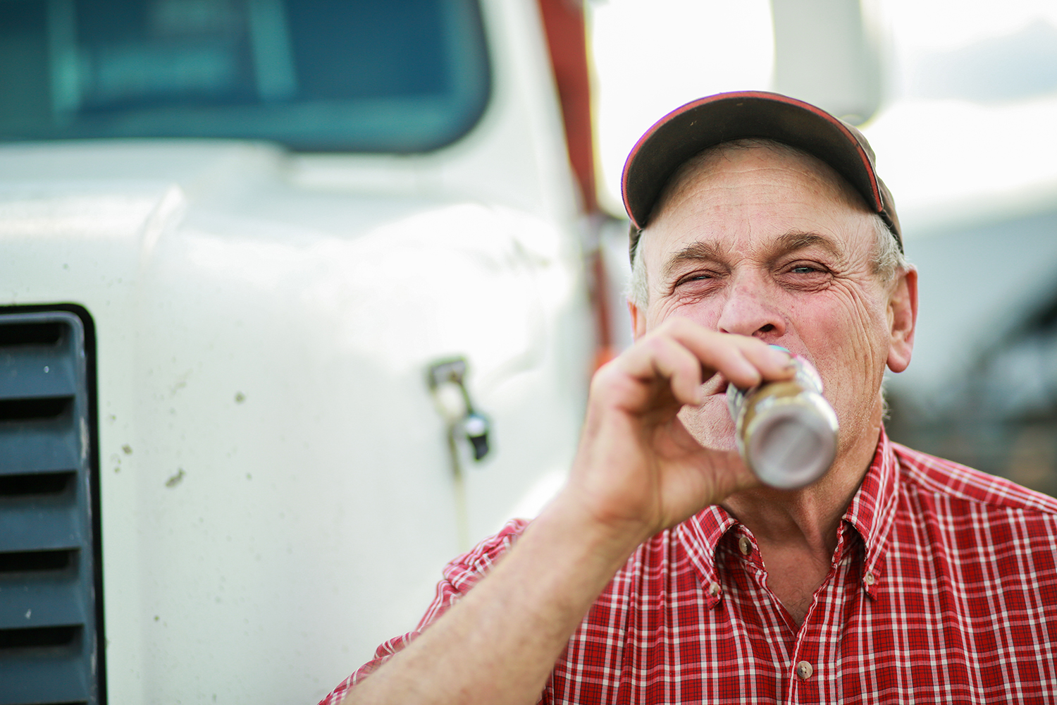 Man drinking chocolate milk in front of a truck