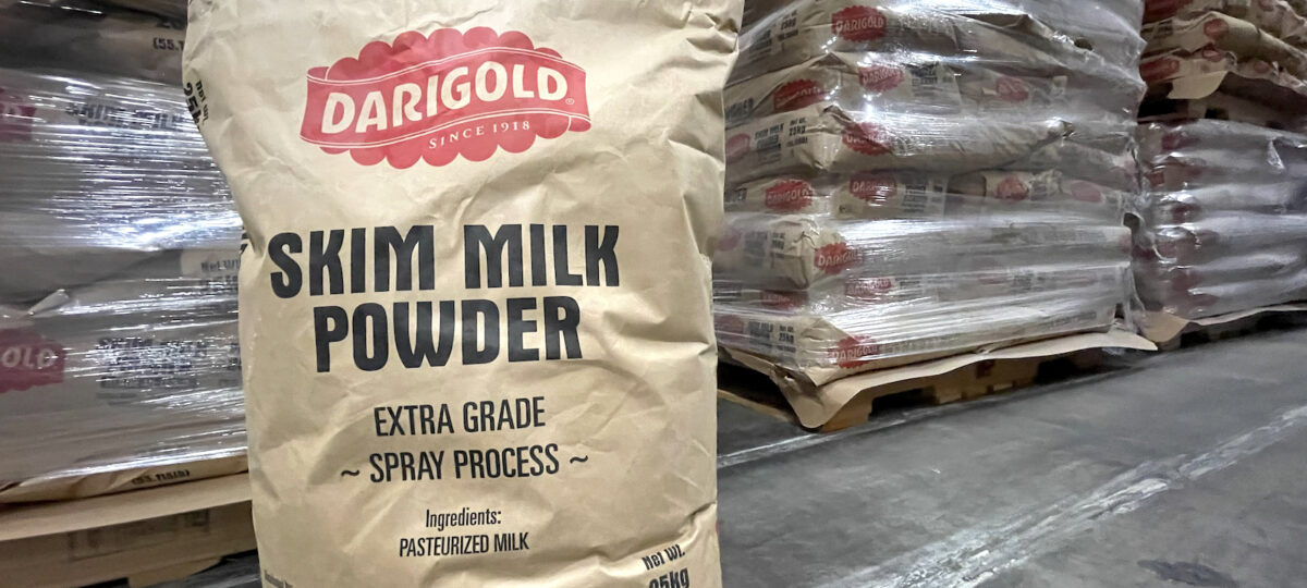 Image of ground 25kg bag of Darigold skim milk powder in a warehouse.