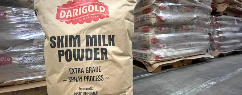 Image of ground 25kg bag of Darigold skim milk powder in a warehouse.