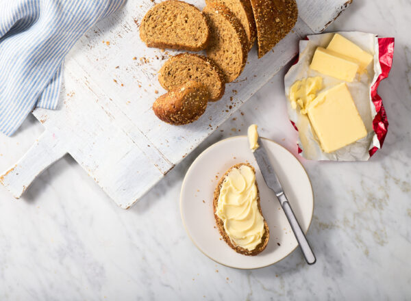 Creative product shot featuring Darigold butter spread on a slice of bread