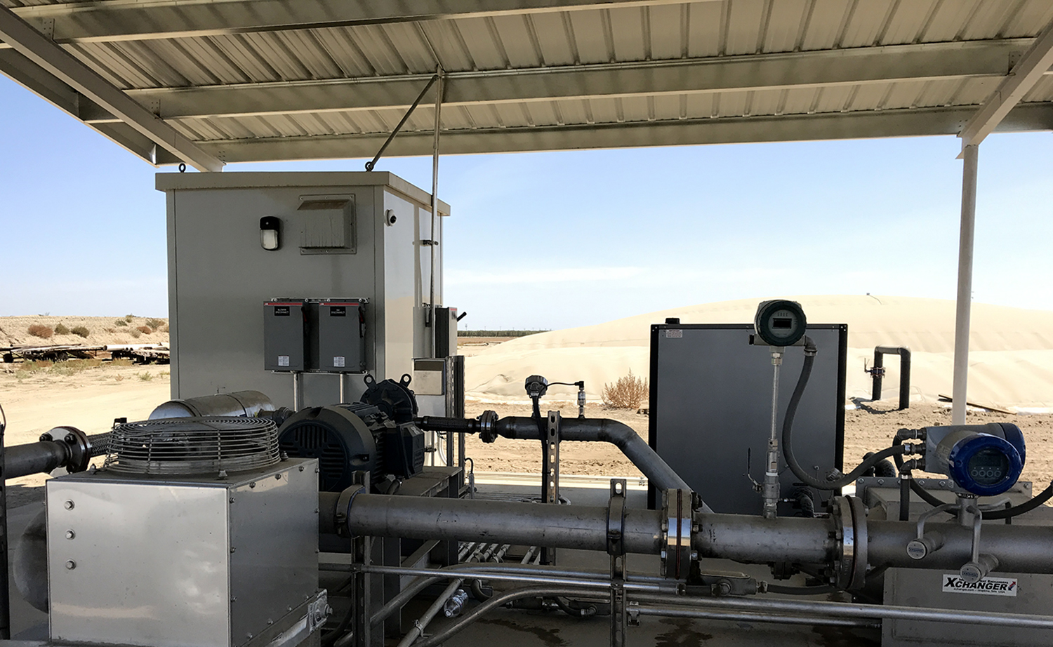 Industrial equipment covered by a metal roof in the desert