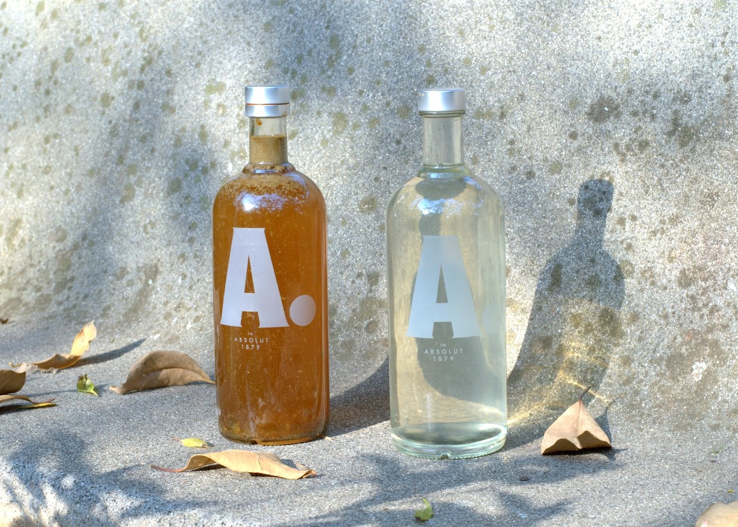 Two Absolut bottles show before and after water treatment system