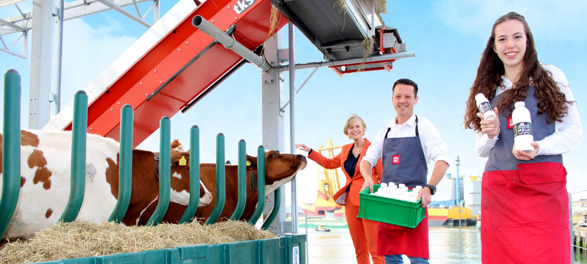 People pose with cows and bottles of milk