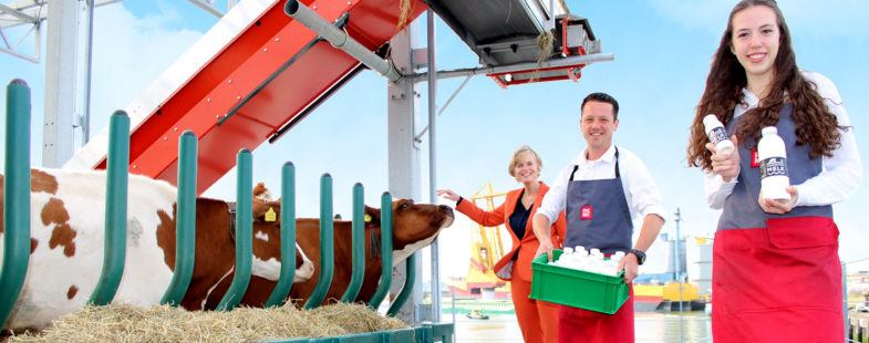 People pose with cows and bottles of milk