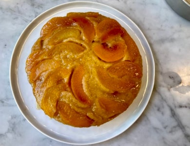 Honey Peach Cake on a silver tray on a marble table