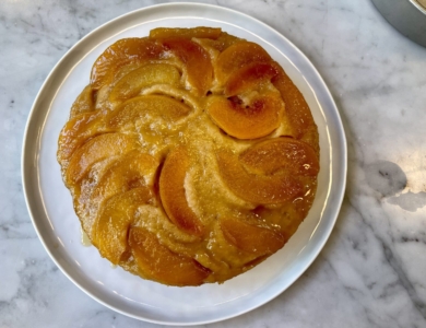 Honey Peach Cake on a silver tray on a marble table