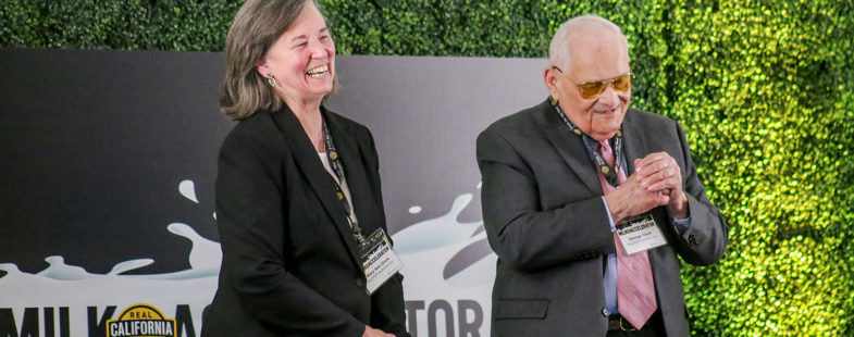 Elderly married couple on a stage with green background