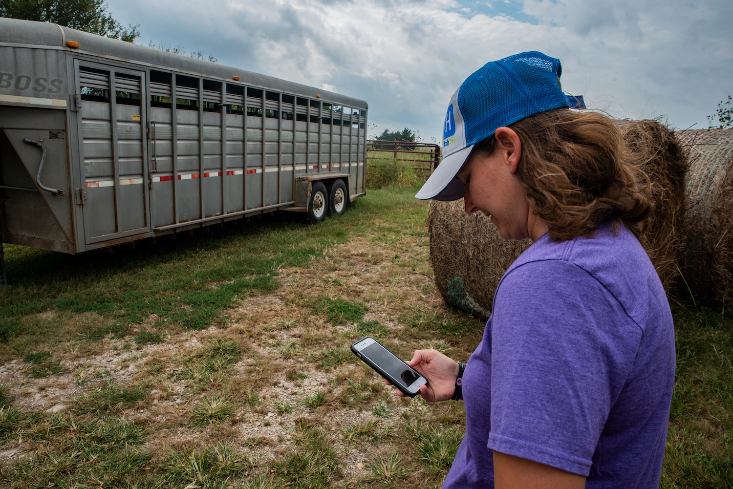 Woman on her phone in a farm field