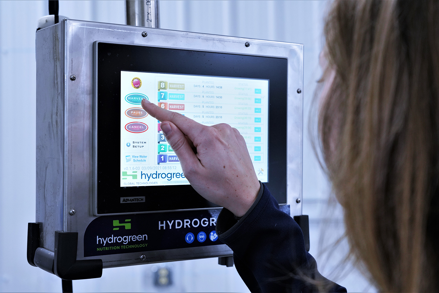 A woman interacts with a digital screen