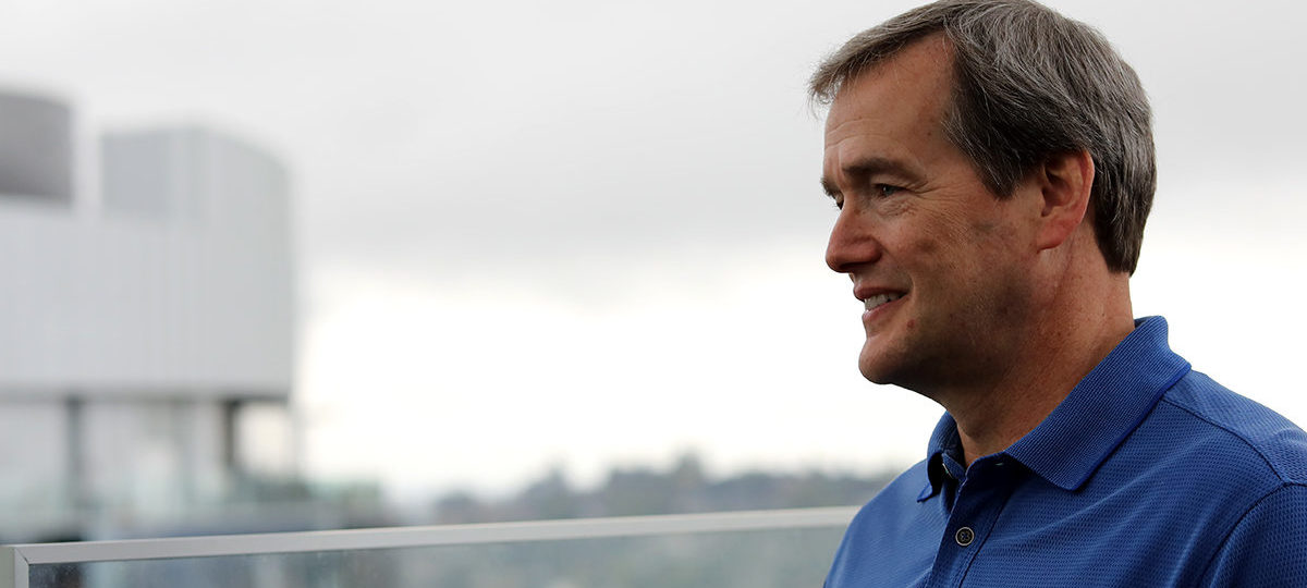 Portrait of man with blue shirt and city background