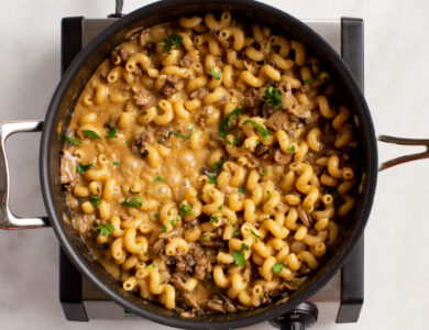 A skillet of cheesy pasta on a single burner