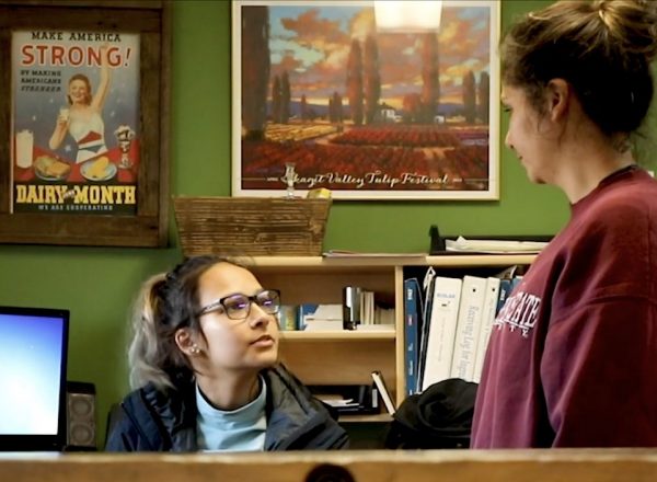 A mother and her daughter in conversation inside a colorful office