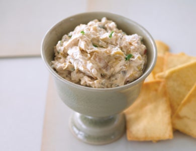 Decorative bowl of dip with pita chips