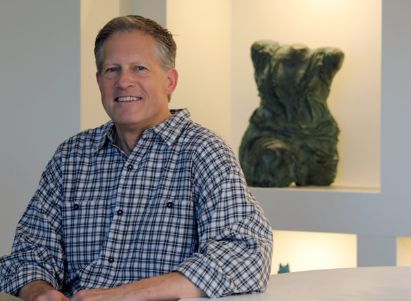 Portrait of a man in front of a bust