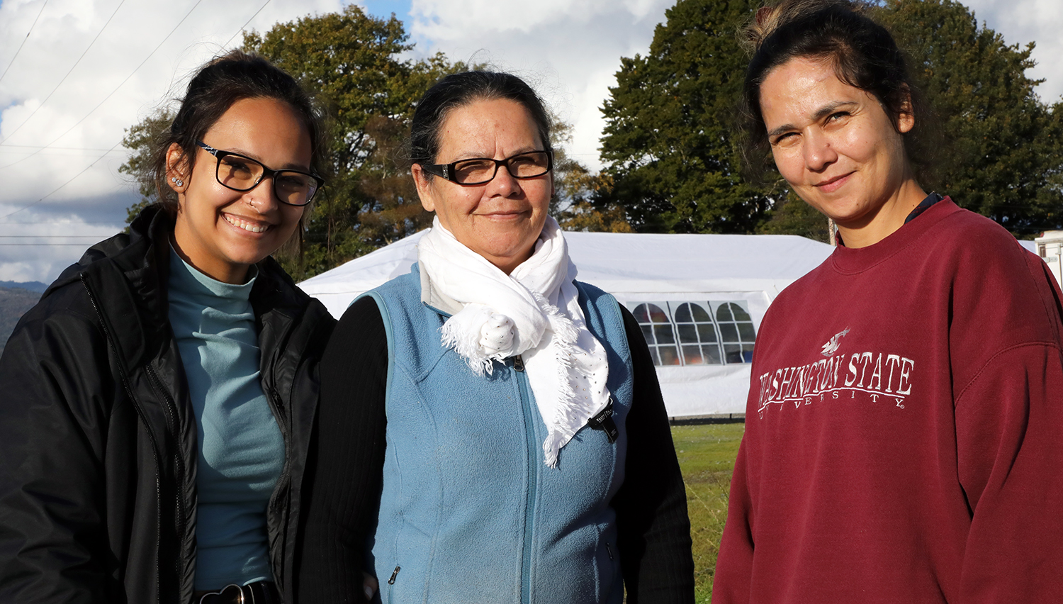 Three Latina women pose for a group photo