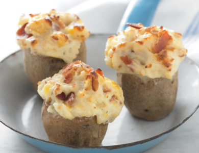 Three stuffed potatoes in a white enameled pan