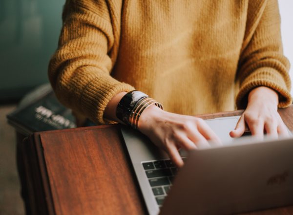 Stock photo of a woman writing on a laptop