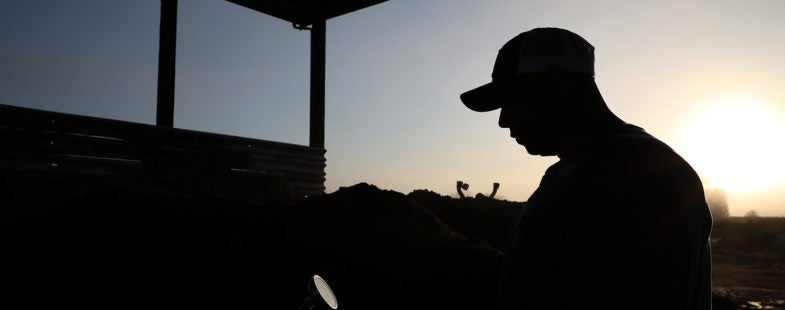 Silhouette of a man on a farm