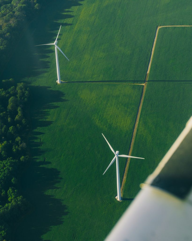 Aerial view of wind turbines in a grass field