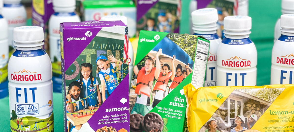 Boxes of Girl Scout cookies and single serve bottles of Darigold FIT milk.