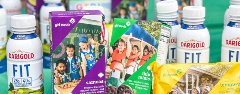 Boxes of Girl Scout cookies and single serve bottles of Darigold FIT milk.