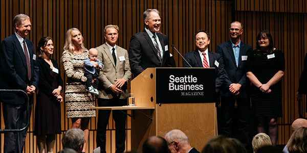 A group of professionally-dressed people on a stage